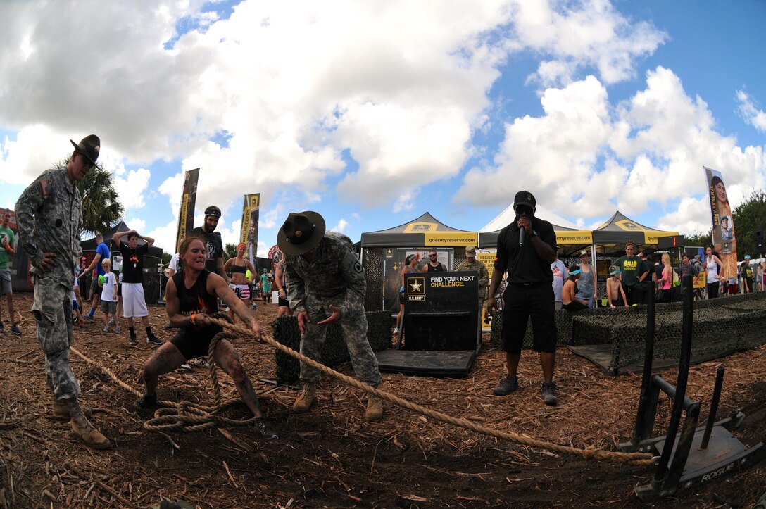 A participant pulls a sled while racing through the Army Reserve Fitness Challenge during day one of the 2015 Tough Mudder at Palm Bay Fla., Nov. 8. A team of drill sergeants was present motivating and critiquing the participants as they took on the challenge. The drill sergeants guaranteed that competitors got a feel of how it’s like working under stress and urgency by yelling commands and creating a stressful environment while ensuring the competitors navigated the course using proper Army technique. The timed challenge was comprised of five Army themed exercises in which volunteers competed for prizes and spots on the daily leaderboard.