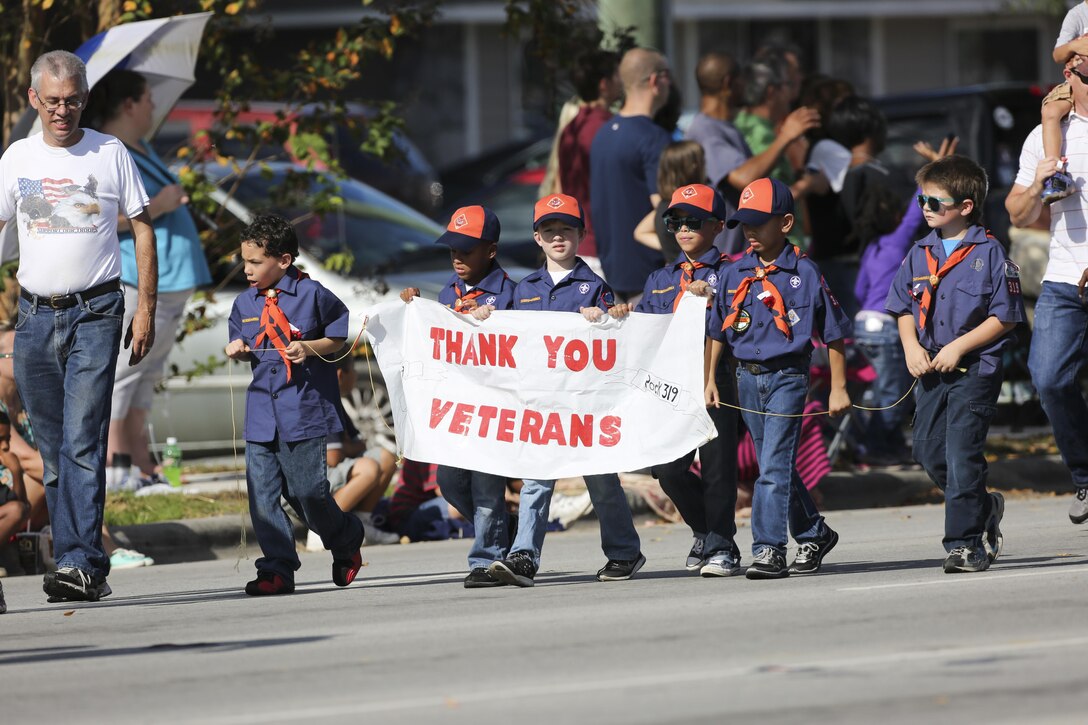 Cub Scouts carry a banner during the 20th Annual Veterans Day Parade in Jacksonville, N.C., Nov. 7, 2015. The Veterans Day parade, hosted by Rolling Thunder, allowed veterans, service members and residents of Jacksonville to show support for members of the armed forces. U.S. Marine Corps photo by Staff Sgt. Neill A. Sevelius