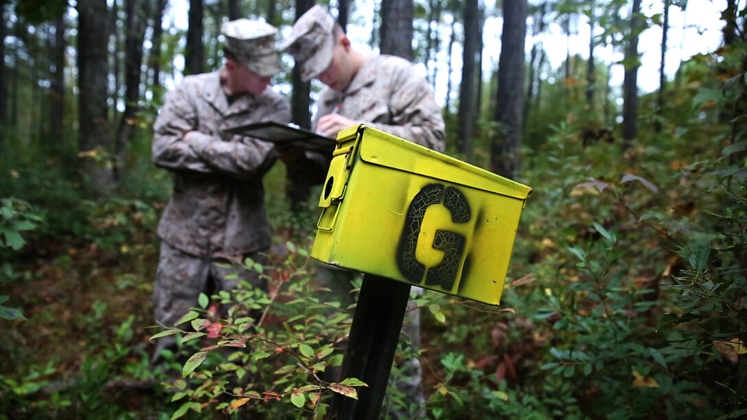 Marines with Motor transportation Company, 2nd Maintenance Battalion, take down the name of one of the five points during a land navigation course at Marine Corps Base Camp Lejeune, N.C. Oct. 28th, 2015. Participants of the course were allotted three hours to successfully plot points and reach those points. The Marines covered several hundred meters of ground over the given time. (U.S. Marine Corps video illustration by Lance Cpl. Dalton Precht/released)