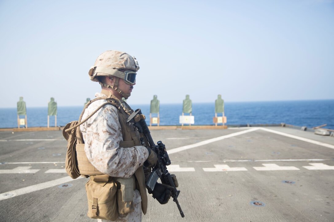 GULF OF ADEN (Oct. 20, 2015) U.S. Marine Lance Cpl. Justin Mudge prepares to engage his target during a marksmanship qualification course aboard the USS Rushmore (LSD 47). Mudge is an amphibious assault vehicle crewman with Kilo Company, Battalion Landing Team 3rd Battalion, 1st Marine Regiment, 15th Marine Expeditionary Unit. The marksmanship course focused on retaining basic marksmanship skills which prepares them for potential operations while deployed with the 15th MEU. (U.S. Marine Corps photo by Sgt. Emmanuel Ramos/Released)