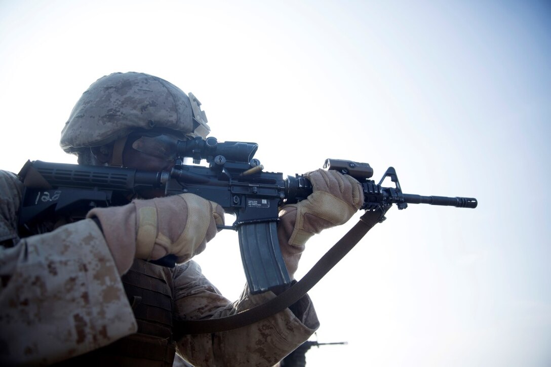 GULF OF ADEN (Oct. 20, 2015) U.S. Marine Lance Cpl. Willy Jackson engages his target during a marksmanship qualification course aboard the USS Rushmore (LSD 47). Jackson is an amphibious assault vehicle crewman with Kilo Company, Battalion Landing Team 3rd Battalion, 1st Marine Regiment, 15th Marine Expeditionary Unit. The marksmanship course focused on retaining basic marksmanship skills which prepares them for potential operations while deployed with the 15th MEU. (U.S. Marine Corps photo by Sgt. Emmanuel Ramos/Released)