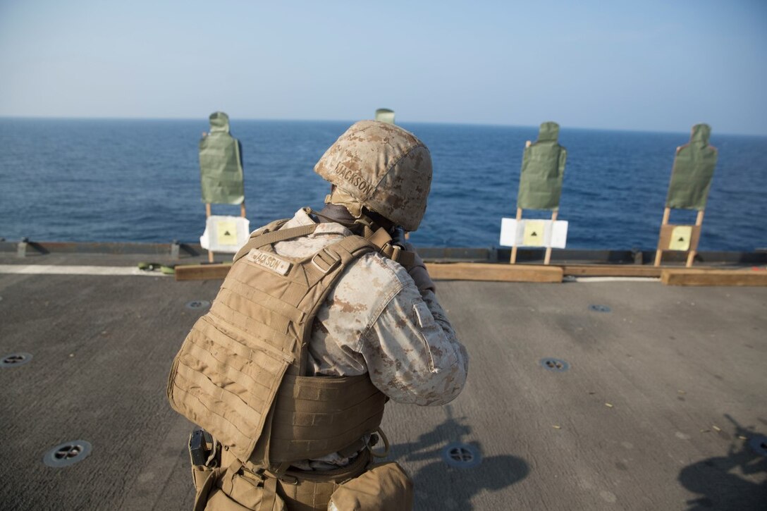 GULF OF ADEN (Oct. 20, 2015) U.S. Marine Lance Cpl. Willy Jackson engages his target during a marksmanship qualification course aboard the USS Rushmore (LSD 47). Jackson is an amphibious assault vehicle crewman with Kilo Company, Battalion Landing Team 3rd Battalion, 1st Marine Regiment, 15th Marine Expeditionary Unit. The marksmanship course focused on retaining basic marksmanship skills which prepares them for potential operations while deployed with the 15th MEU. (U.S. Marine Corps photo by Sgt. Emmanuel Ramos/Released)
