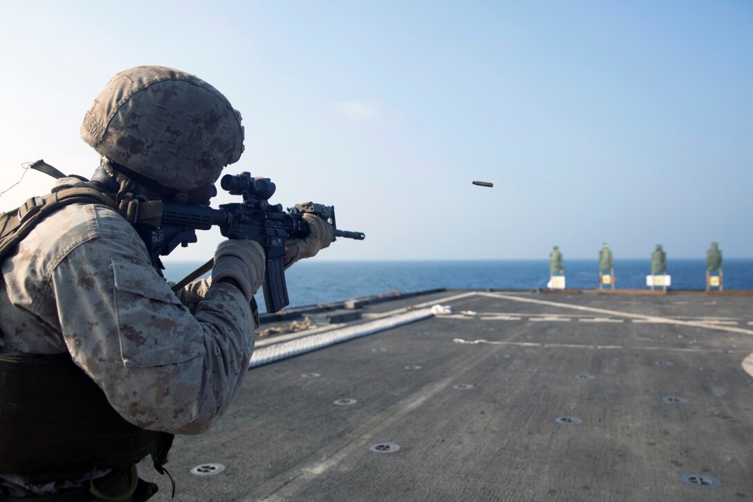 GULF OF ADEN (Oct. 20, 2015) U.S. Marine Lance Cpl. Willy Jackson engages his target during a marksmanship qualification course aboard the USS Rushmore (LSD 47). Jackson is an amphibious assault vehicle crewman with Kilo Company, Battalion Landing Team 3rd Battalion, 1st Marine Regiment, 15th Marine Expeditionary Unit. The marksmanship course focused on retaining basic marksmanship skills which prepares them for potential operations while deployed with the 15th MEU. (U.S. Marine Corps photo by Sgt. Emmanuel Ramos/Released)