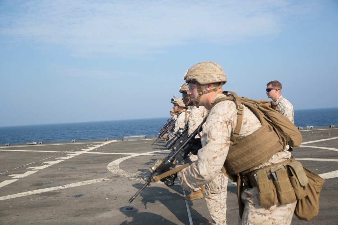 GULF OF ADEN (Oct. 20, 2015) U.S. Marines with Kilo Company, Battalion Landing Team 3rd Battalion, 1st Marine Regiment, 15th Marine Expeditionary Unit, prepare to fire at targets during a marksmanship qualification course aboard the USS Rushmore (LSD 47). The marksmanship course focused on retaining basic marksmanship skills which prepares them for potential operations while deployed with the 15th MEU. (U.S. Marine Corps photo by Sgt. Emmanuel Ramos/Released)