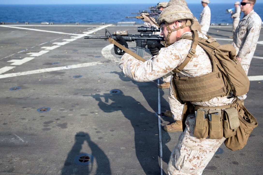 GULF OF ADEN (Oct. 20, 2015) U.S. Marines with Kilo Company, Battalion Landing Team 3rd Battalion, 1st Marine Regiment, 15th Marine Expeditionary Unit, prepare to fire at targets during a marksmanship qualification course aboard the USS Rushmore (LSD 47). The marksmanship course focused on retaining basic marksmanship skills which prepares them for potential operations while deployed with the 15th MEU. (U.S. Marine Corps photo by Sgt. Emmanuel Ramos/Released)