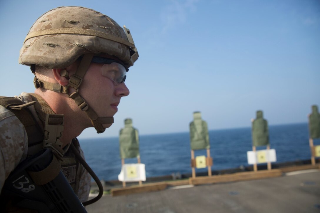 GULF OF ADEN (Oct. 20, 2015) U.S. Marine Cpl. Shawn Obrien prepares to engage his target during a marksmanship qualification course aboard the USS Rushmore (LSD 47). Obrien is an amphibious assault vehicle crew chief with Kilo Company, Battalion Landing Team 3rd Battalion, 1st Marine Regiment, 15th Marine Expeditionary Unit. The marksmanship course focused on retaining basic marksmanship skills which prepares them for potential operations while deployed with the 15th MEU. (U.S. Marine Corps photo by Sgt. Emmanuel Ramos/Released)