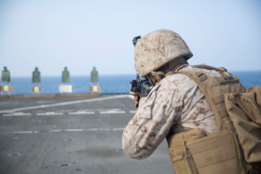 GULF OF ADEN (Oct. 20, 2015) U.S. Marine Lance Cpl. David Medina engages his target during a marksmanship qualification course aboard the USS Rushmore (LSD 47). Medina is an amphibious assault vehicle crewman with Kilo Company, Battalion Landing Team 3rd Battalion, 1st Marine Regiment, 15th Marine Expeditionary Unit. The marksmanship course focused on retaining basic marksmanship skills which prepares them for potential operations while deployed with the 15th MEU. (U.S. Marine Corps photo by Sgt. Emmanuel Ramos/Released)
