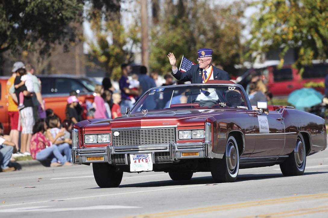 U.S. Marine Corps Sgt. Maj. Michael J. Rooney, Ret., waves during the 20th Annual Veterans Day Parade in Jacksonville, N.C., Nov. 7, 2015. The parade, hosted by Rolling Thunder, allowed veterans, service members and residents of Jacksonville to show support for members of the armed forces. U.S. Marine Corps photo by Staff Sgt. Neill A. Sevelius