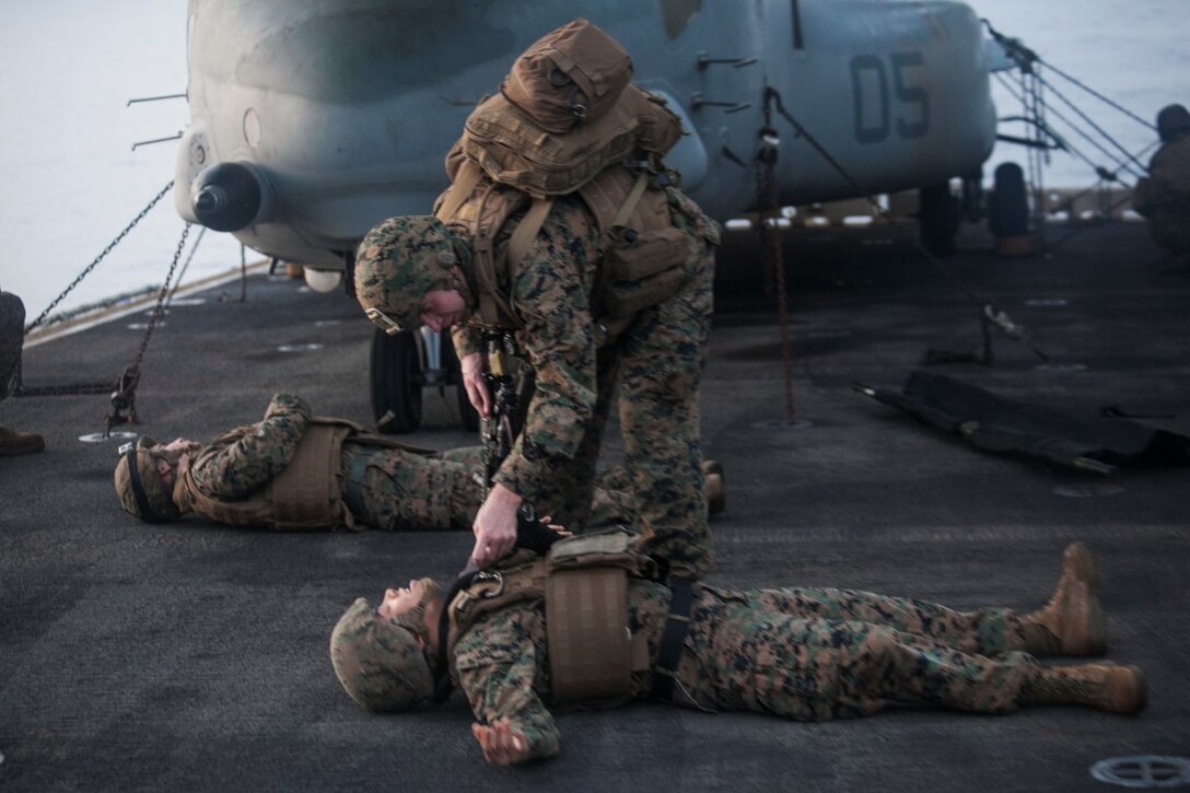 INDIAN OCEAN (Nov. 4, 2015) A U.S. Sailor with Combat Logistics Battalion 15, 15th Marine Expeditionary Unit, tends to a simulated causality during a mass-casualty drill on the flight deck of the USS Essex (LHD 2).The Marines and Sailors honed their skills to become quicker and more efficient should a situation arise where medical attention is needed. The 15th MEU is currently deployed in the Indo-Asia-Pacific region to promote regional stability and security in the U.S. 7th Fleet area of operations. (U.S. Marine Corps photo by Cpl. Elize McKelvey/Released)