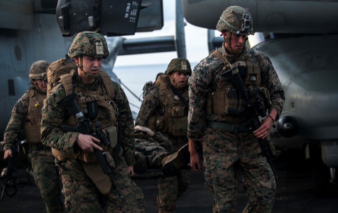 INDIAN OCEAN (Nov. 4, 2015) U.S Marines and Sailors with the 15th Marine Expeditionary Unit transport a simulated causality during a mass-casualty drill on the flight deck of the USS Essex (LHD 2).The Marines and Sailors honed their skills to become quicker and more efficient should a situation arise where medical attention is needed. The 15th MEU is currently deployed in the Indo-Asia-Pacific region to promote regional stability and security in the U.S. 7th Fleet area of operations. (U.S. Marine Corps photo by Cpl. Elize McKelvey/Released)