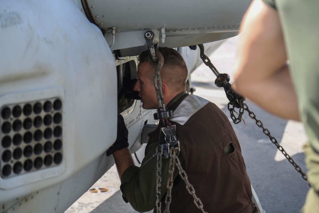 INDIAN OCEAN (Nov. 6, 2015) U.S. Marine Cpl. Ryan Gaedtke inspects an AH-1Z Viper to ensure it is ready for flight aboard the USS Anchorage (LPD 23). Gaedtke is a plane captain with Marine Medium Tiltrotor Squadron 161 (Reinforced), 15th Marine Expeditionary Unit. The 15th MEU is currently deployed in the Indo-Asia-Pacific region to promote regional stability and security in the U.S. 7th Fleet area of operations. (U.S. Marine Corps photo by Sgt. Steve H. Lopez/Released)