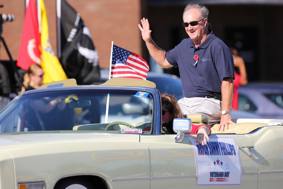 Sammy Phillips, mayor of Jacksonville, N.C., waves during the 20th Annual Veterans Day Parade in Jacksonville, N.C., Nov. 7, 2015. The Veterans Day parade, hosted by Rolling Thunder, allowed veterans, service members and residents of Jacksonville to show support for members of the armed forces. U.S. Marine Corps photo by Staff Sgt. Neill A. Sevelius