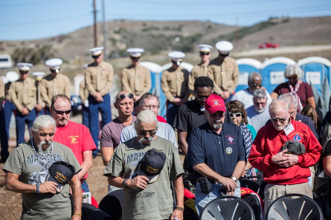 Active duty Marines and Sailors and their veteran predecessors of 2nd Battalion, 1st Marine Regiment bow their heads in silence during the benediction portion of a ceremony Nov. 6, 2015, aboard Marine Corps Base Camp Pendleton, Calif., honoring members of their regiment who gave their lives during the Vietnam War. During the ceremony, plaques bearing the names of the fallen were dedicated in their honor at the Camp Horno Memorial Garden. (U.S. Marine Corps photo by Lance Cpl. Alvin Pujols/Released)