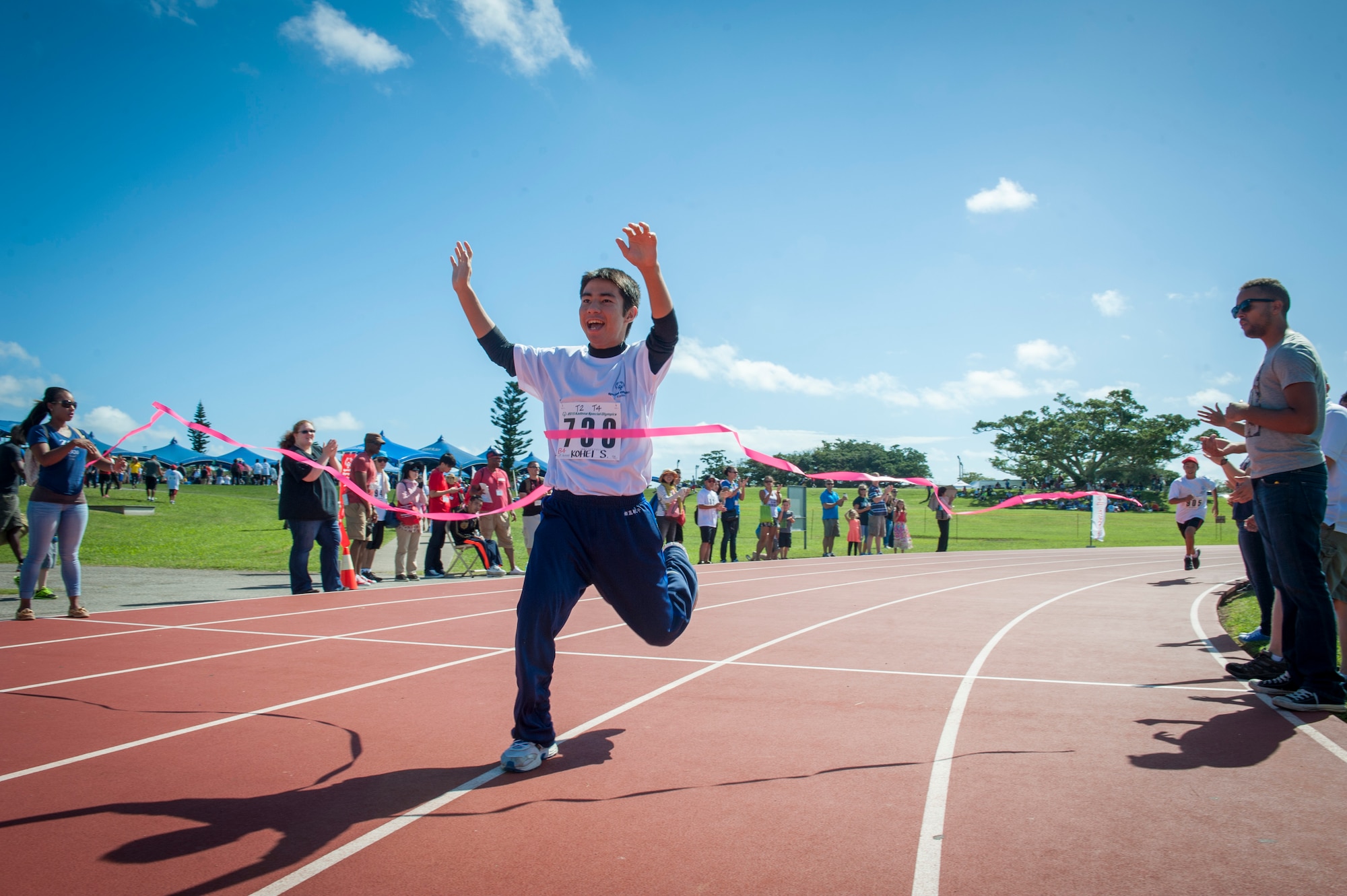 Kohei Setake, a Kadena Special Olympics athlete, wins first place in a 200 meter dash during the Kadena Special Olympics Nov. 7, 2015, at Kadena Air Base, Japan. Established by the 18th Wing commander in 2000, KSO is a sporting and entertainment event that provides an opportunity for all communities involved to stand together in support of people with special needs. (U.S. Air Force photo by Airman 1st Class Lynette M. Rolen)