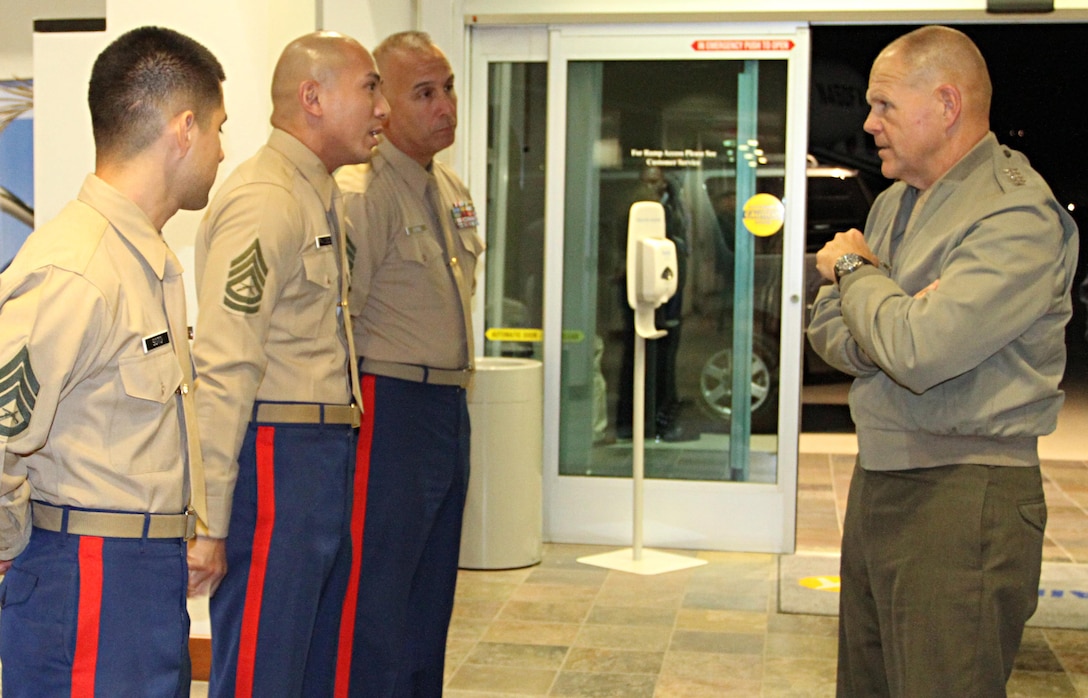 Commandant of the Marine Corps, Gen. Robert B. Neller, speaks with Marines of Recruiting Station Los Angeles, Nov. 6, 2015, and recognizes them for winning the Western Region annual awards. Staff Sgt. Francisco Soto, left, from Recruiting Sub Station Granada Hills, won recruiter of the year for the Western Region, and Gunnery Sgt. Andrew Francisco, center, staff noncommissioned officer in charge of RSS Granada Hills, won, SNCOIC of the year for the Western Region. The commandant presented the Marines with his challenge coin for a job well done. (U.S. Marine Corps photo by Sgt. Alicia R. Leaders/Released)