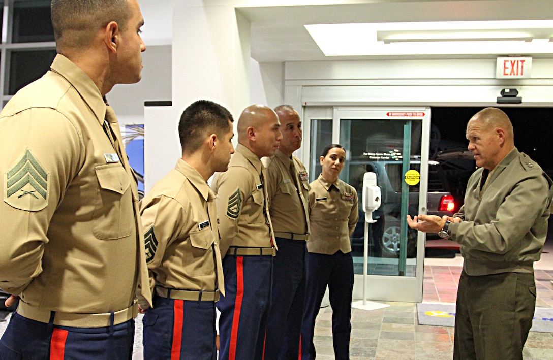 Commandant of the Marine Corps, Gen. Robert B. Neller, speaks with Marines of Recruiting Station Los Angeles, Nov. 6, 2015, and recognizes them for winning the Western Region annual awards. (From left to right) Sgt. Jose Morales, recruiter with Recruiting Sub Station Downey, won rookie recruiter of RS Los Angeles, Staff Sgt. Francisco Soto, with RSS Granada Hills, won recruiter of the year for the Western Region, and Gunnery Sgt. Andrew Francisco, staff noncommissioned officer in charge of RSS Granada Hills, won, SNCOIC of the year for the Western Region. The commandant presented the Marines with his challenge coin for a job well done. (U.S. Marine Corps photo by Sgt. Alicia R. Leaders/Released)