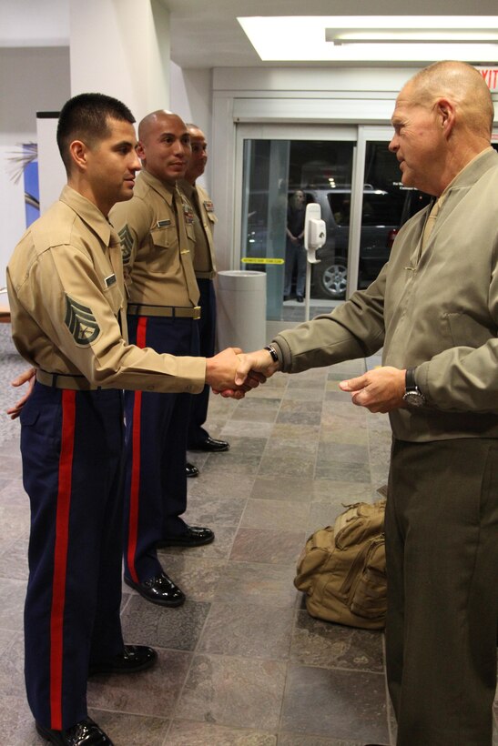 Commandant of the Marine Corps, Gen. Robert B. Neller, presents Staff Sgt. Francisco Soto, recruiter from Recruiting Sub Station Granada Hills, with his challenge coin, Nov. 6, 2015, after winning recruiter of the year for the Western Region. The commandant flew in to Los Angeles to attend the Reagan National Defense Forum, and upon landing at the Camarillo airport, he recognized the Marines for their hard work and dedication in recruiting efforts. (U.S. Marine Corps photo by Sgt. Alicia R. Leaders/Released)