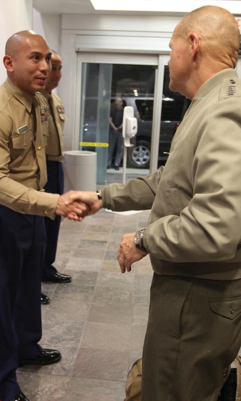 Commandant of the Marine Corps, Gen. Robert B. Neller, presents Gunnery Sgt. Andrew Francisco, staff noncommissioned officer of Recruiting Sub Station Granada Hills, with his challenge coin, Nov. 6, 2015, after winning SNCOIC of the year for the Western Region. The commandant flew in to Los Angeles to attend the Reagan National Defense Forum, and upon landing at the Camarillo airport, he recognized the Marines for their hard work and dedication in recruiting efforts. (U.S. Marine Corps photo by Sgt. Alicia R. Leaders/Released)