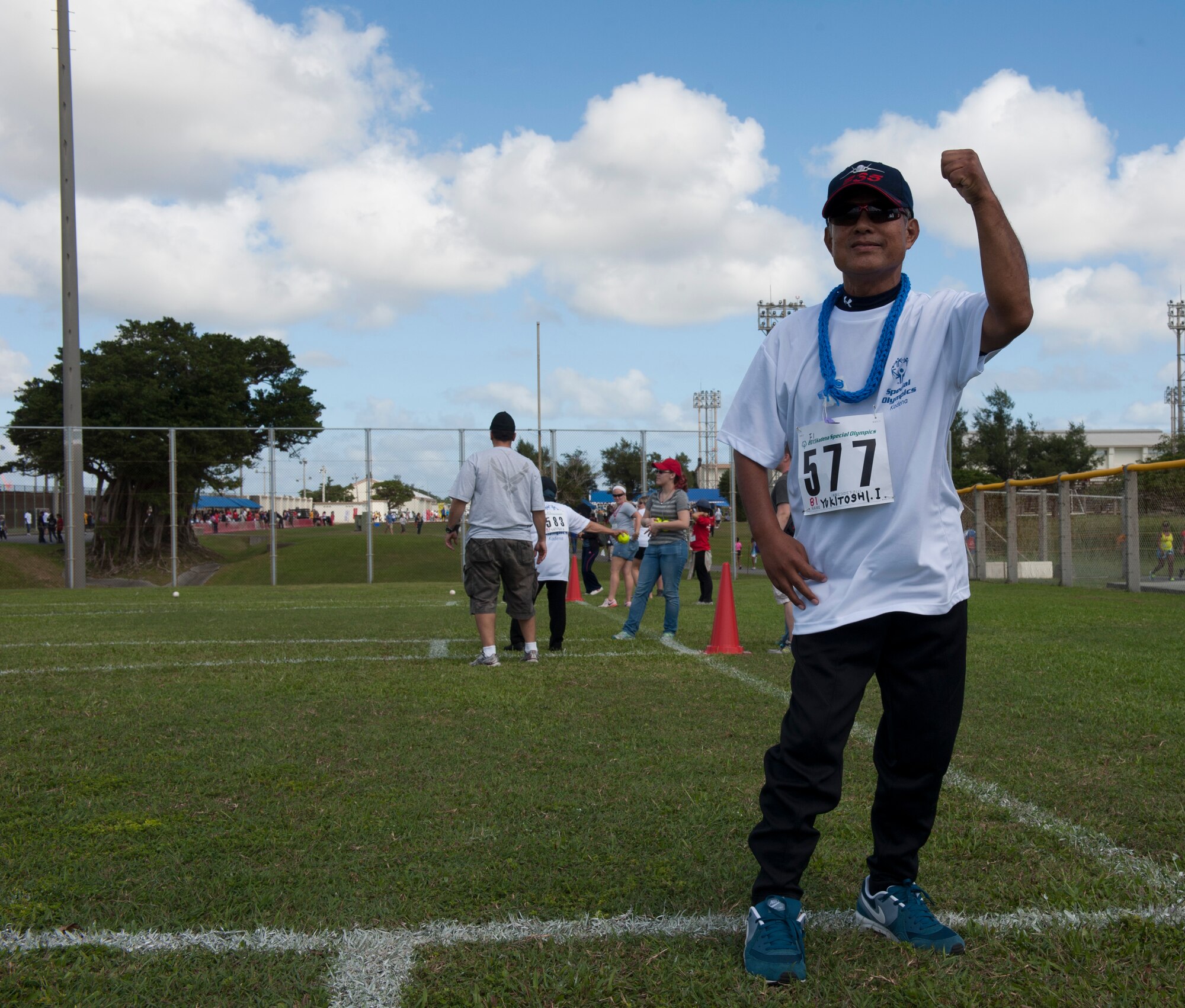 Yukitoshi Iriishigaki, a Kadena Special Olympics athlete, cheers after throwing a softball during the Kadena Special Olympics Nov. 7, 2015, at Kadena Air Base, Japan. KSO is a non-profit activity managed by volunteers from around the island and funded by donations as a goodwill initiative to give back to those with special needs. (U.S. Air Force photo by Airman 1st Class Lynette M. Rolen/Relased)