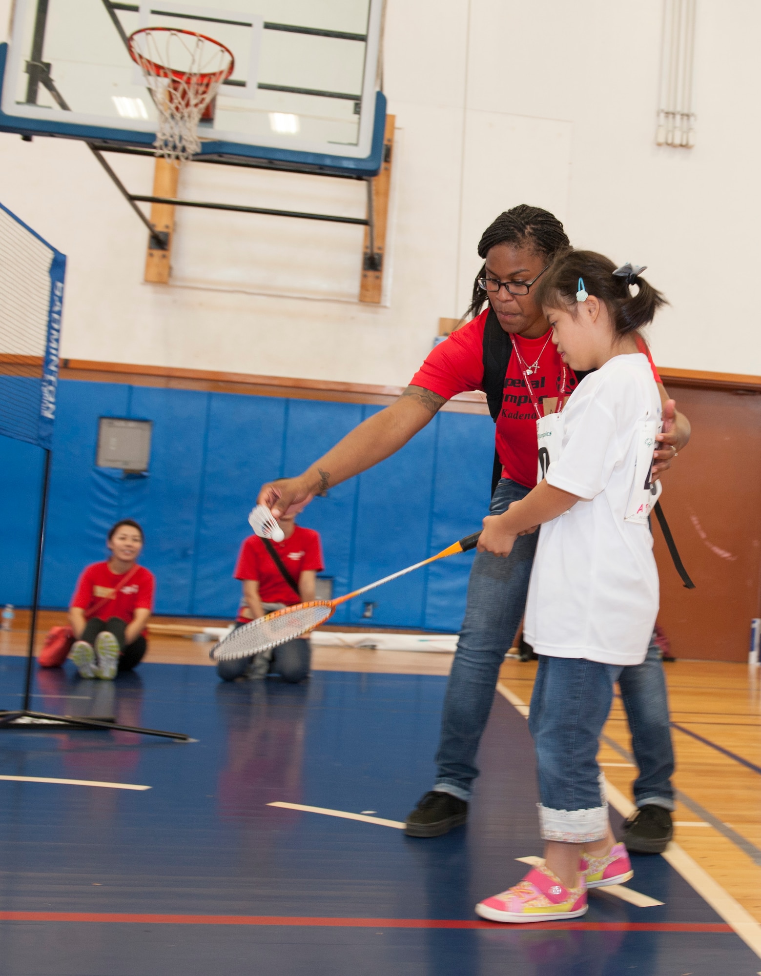 U.S. Air Force Airman 1st Class Amiya Jones, 18th Security Forces Squadron armorer, helps Yuri Yonaha, a Kadena Special Olympics athlete, with her badminton skills during the Kadena Special Olympics Nov. 7, 2015, at Kadena Air Base, Japan. This year marks the 16th anniversary of KSO, a sporting event dedicated to enriching the lives of American and Okinawan special needs individuals on the island. (U.S. Air Force photo by Airman 1st Class Lynette M. Rolen/Released)