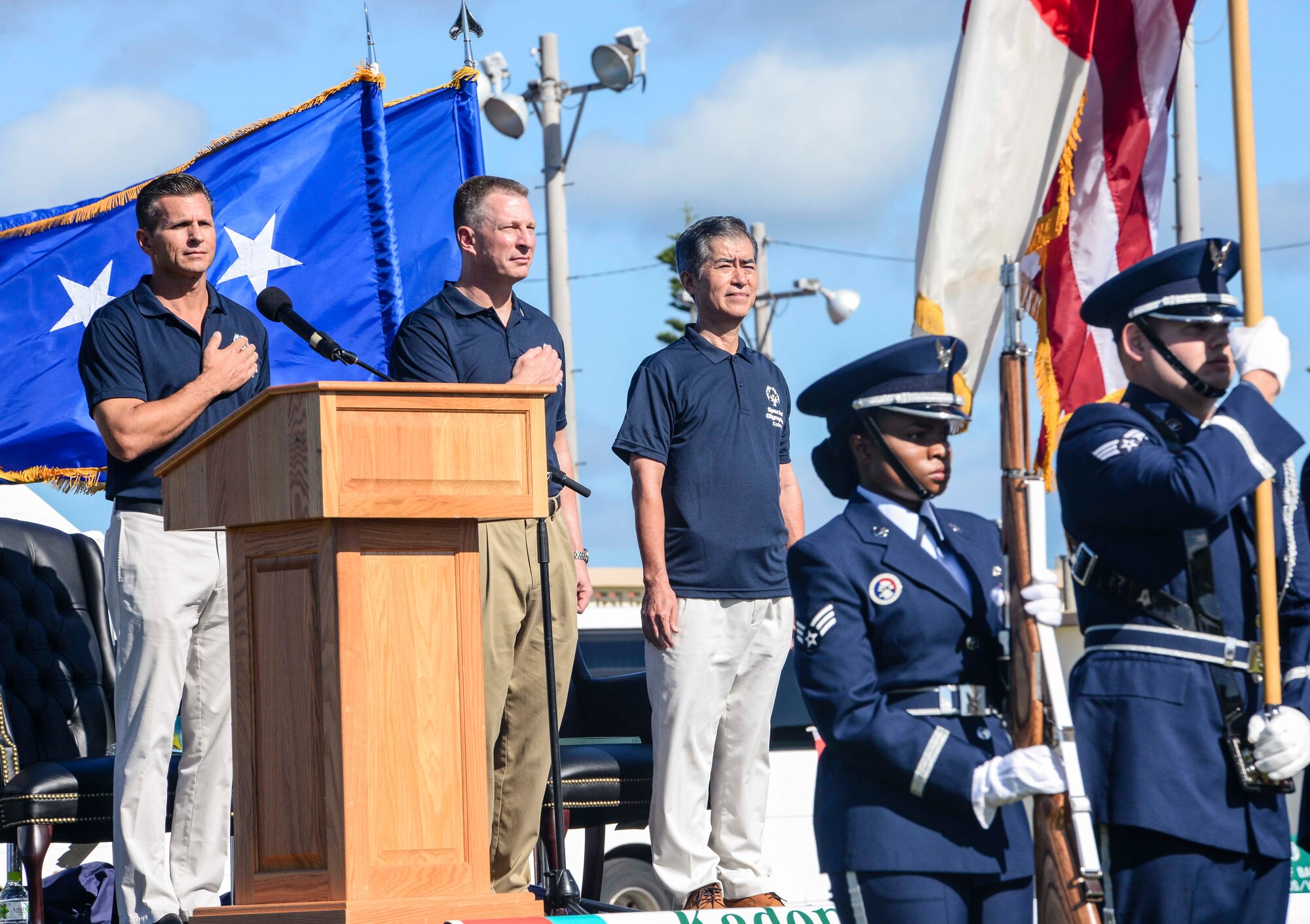 U.S. Air Force Brig. Gen. Barry Cornish, 18th Wing commander, U.S. Air Force Lt. Gen. John Dolan, 5th Air Force commander, and Masaru Machida, Okinawa Prefectural Government Executive Office of the Governor director general, stand as the U.S. National Anthem is played during the Kadena Special Olympics opening ceremony Nov. 7, 2015, at Kadena Air Base, Japan. The KSO is sponsored by the 18th Wing and the Friends of Kadena Special Olympics in partnership with the Okinawa Prefectural Government, Okinawa City, Kadena Town, Chatan Town and all U.S. military services on island. (U.S. Air Force photo by Senior Airman John Linzmeier/Released) 