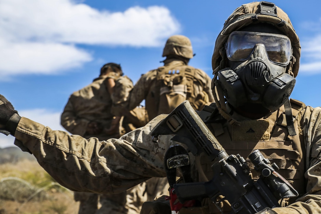 Marines move through concertina wire during Exercise Lava Viper on Pohakuloa Training Area, Hawaii, Nov.  4, 2015. The training allows Marines to utilize tactics and weapons while organizing within platoons. U.S. Marine Corps photo by Lance Cpl. Harley Thomas