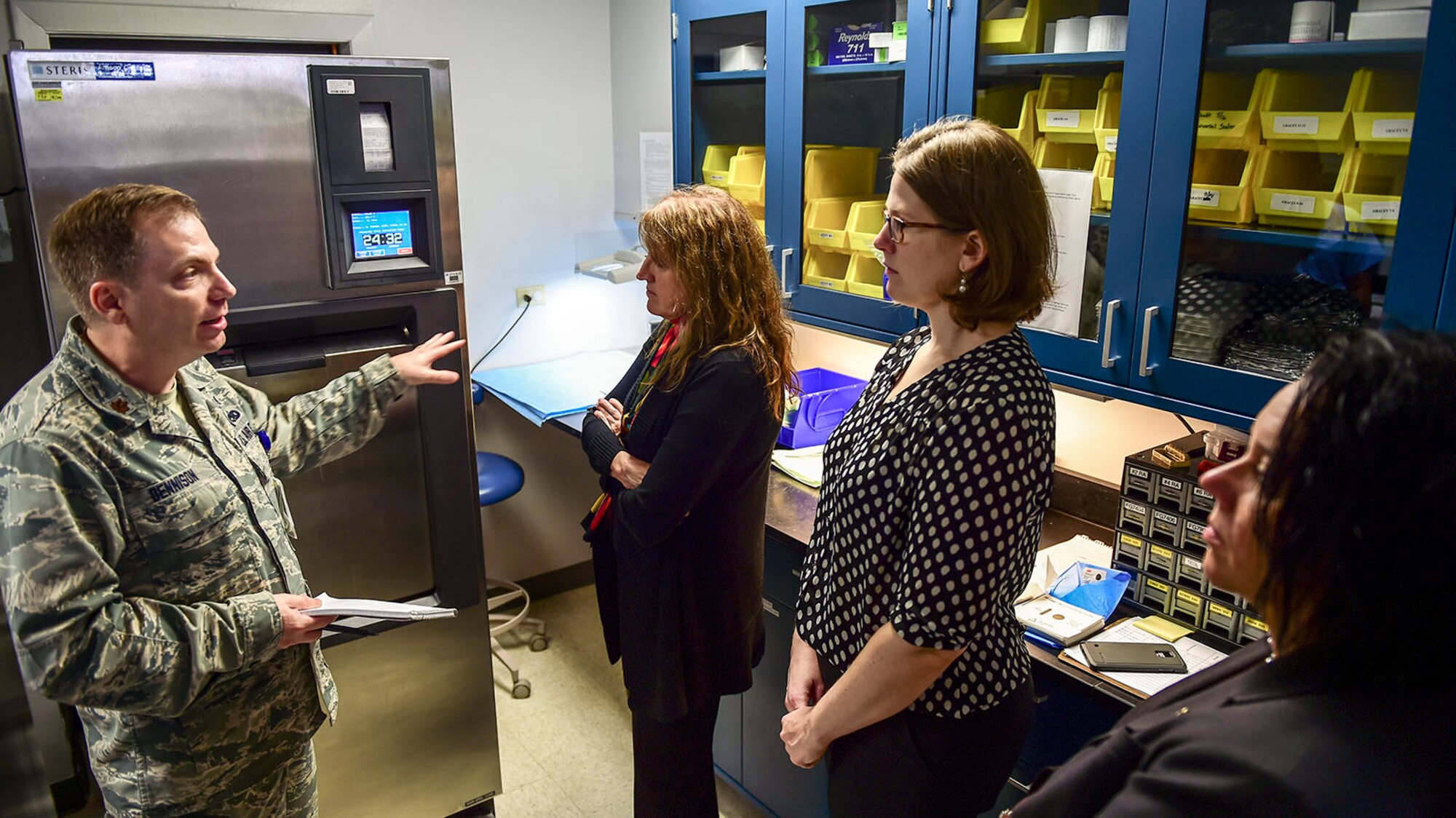Maj. David Dennison, 359th Aerospace Medicine Squadron, briefs a group of health care consultants at the Randolph Clinic, Oct. 22, 2015, on Joint Base San Antonio-Randolph, Texas. Dennison explained the new sanitization procedures that the clinic implemented to ensure patient safety. (U.S. Air Force photo/Staff Sgt. Michael Ellis)
