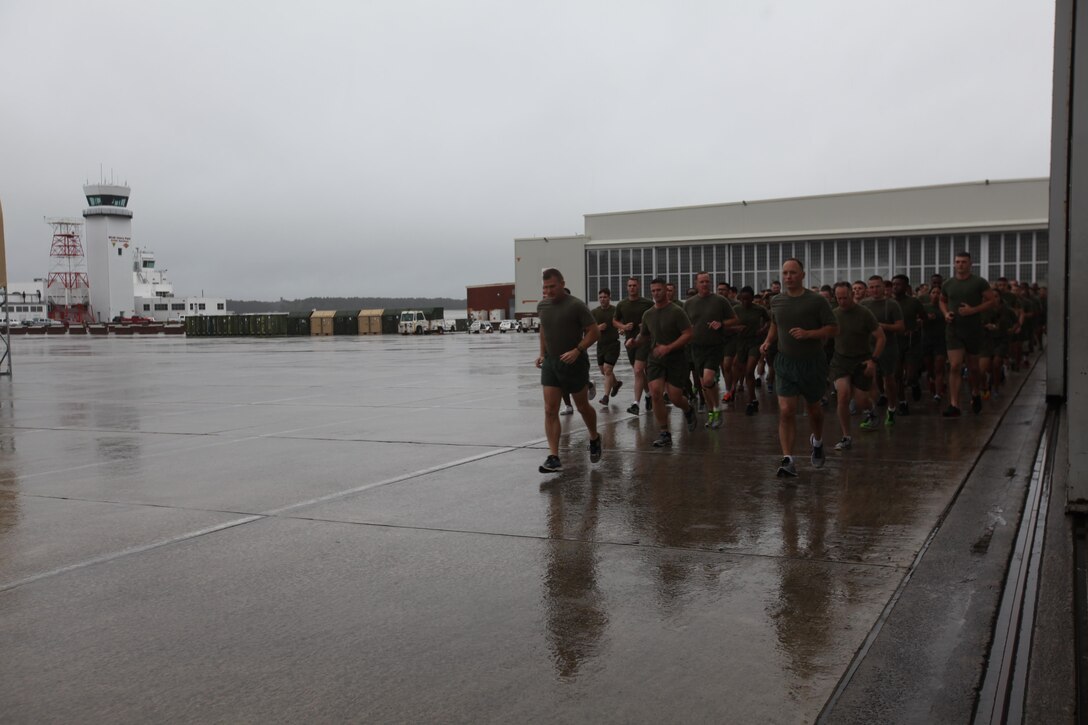 Hundreds of Marines run through rain across the flight line during the Marine Corps birthday run at Marine Corps Air Station Cherry Point, N.C., Nov. 9, 2015. More than 1,500 Marines and Sailors with 2nd Marine Aircraft Wing and MCAS Cherry Point participated in a motivational run to commemorate the Marine Corps’ 240th birthday. The run is held annually to celebrate the traditions of the Marine Corps and the camaraderie of the service members. (U.S. Marine Corps photo by Cpl. Unique Roberts/ Released)