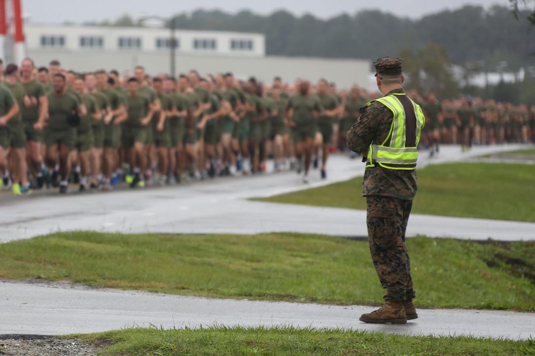 A road guard blocks the entrance to C Street as hundreds of Marines run by during the Marine Corps birthday run at Marine Corps Air Station Cherry Point, N.C., Nov. 9, 2015. More than 1,500 Marines and Sailors with 2nd Marine Aircraft Wing and MCAS Cherry Point participated in the motivational run to commemorate the Marine Corps’ 240th birthday. The run is held annually to celebrate the traditions of the Marine Corps and the camaraderie of the service members. (U.S. Marine Corps photo by Cpl. N.W. Huertas/ Released)
