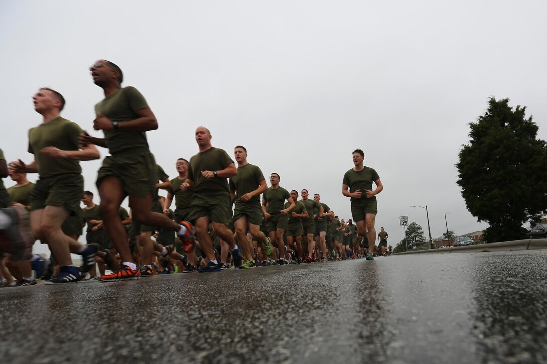 Hundreds of Marines run across wet pavement during the Marine Corps birthday run at Marine Corps Air Station Cherry Point, N.C., Nov. 9, 2015. More than 1,500 Marines and Sailors with 2nd Marine Aircraft Wing and MCAS Cherry Point participated in the motivational run to commemorate the Marine Corps’ 240th birthday. The run is held annually to celebrate the traditions of the Marine Corps and the camaraderie of the service members. (U.S. Marine Corps photo by Cpl. N.W. Huertas/ Released)