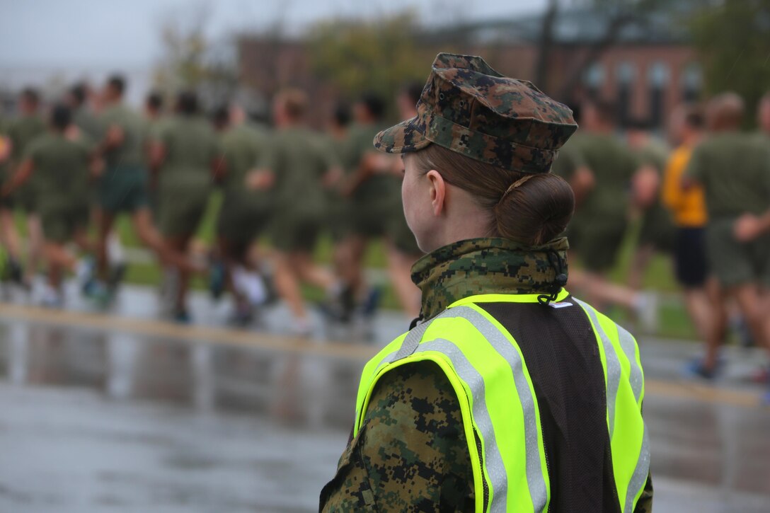 Road guards direct traffic as hundreds of Marines run by senior leaders lead a formation of Marines during the Marine Corps birthday run at Marine Corps Air Station Cherry Point, N.C., Nov. 9, 2015. More than 1,500 Marines and Sailors with 2nd Marine Aircraft Wing and MCAS Cherry Point participated in the motivational run to commemorate the Marine Corps’ 240th birthday. The run is held annually to celebrate the traditions of the Marine Corps and the camaraderie of the service members. (U.S. Marine Corps photo by Cpl. N.W. Huertas/ Released)