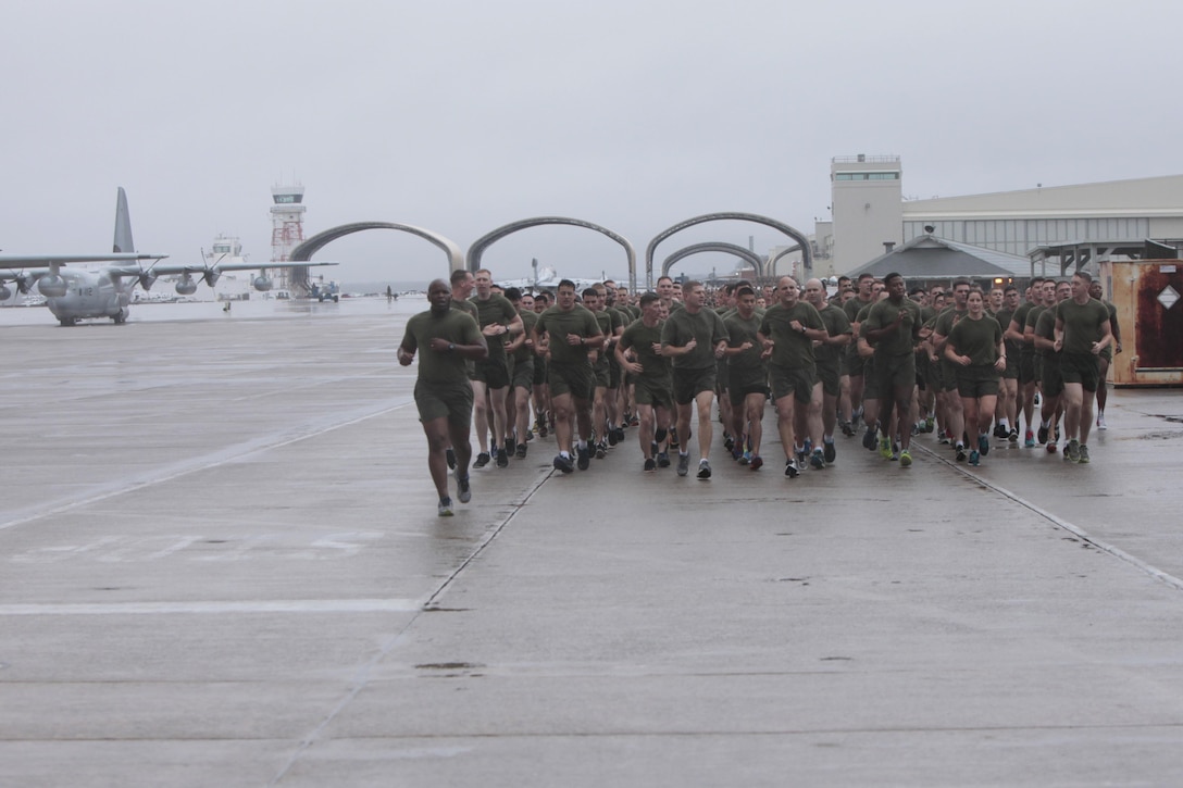 Hundreds of Marines run across the flight line during the Marine Corps birthday run at Marine Corps Air Station Cherry Point, N.C., Nov. 9, 2015. More than 1,500 Marines and Sailors with 2nd Marine Aircraft Wing and MCAS Cherry Point participated in the motivational run to commemorate the Marine Corps’ 240th birthday. The run is held annually to celebrate the traditions of the Marine Corps and the camaraderie of the service members. (U.S. Marine Corps photo by Sgt. Grace L. Waladkewics/ Released)