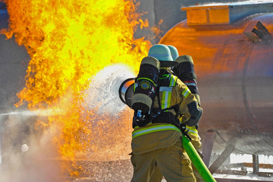 Civilian firefighters from U.S. Army Europe participate in the annual Firefighter II training at the Urlas Firefighting Training Center, Ansbach,Germany, Nov. 3, 2015. Tasks included hazardous materials response, fire ground operations, rescue operations and maintenance.  U.S. Army photo by Georgios Moumoulidis