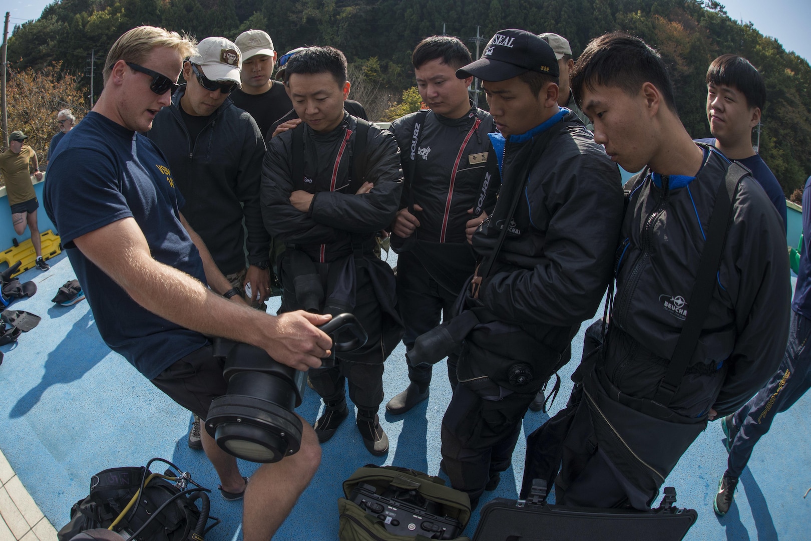 Explosive Ordnance Disposal (EOD) technician 3rd Class Aaron Ainley, left, assigned to EOD Mobile Unit (EODMU) 1, explains the functions of the DNS-300 underwater sonar system to Republic of Korea Navy UDT/SEALs during Exercise Clear Horizon 2015 on Commander Fleet Activities Chinhae.  Exercise Clear Horizon is an annual bilateral exercise between the U.S. and Republic of Korea navies that focus on increasing capabilities and coordination between ships, and aircraft in mine countermeasures in international waters surrounding the Korean peninsula.  (U.S. Navy Combat Camera Photo by Mass Communication Specialist 2nd Class Daniel Rolston/RELEASED)