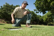 Chris Farley, U.S. Navy veteran and National Memorial Cemetery of the Pacific (NMCP) caretaker, visits the resting place of his parents at the NMCP Nov. 28, 2015, in Honolulu. Farley is a U.S. Navy veteran who served from 1982 to 1987 as an air traffic controller. He is responsible for the maintenance of the 112.5 acres of land that make up the cemetery, the 56,971 grave sites of those who are interred in-ground or in-columbarium, and the 28,788 fallen who are memorialized in the courts of the missing. (U.S. Air Force photo by Staff Sgt. Christopher Hubenthal)