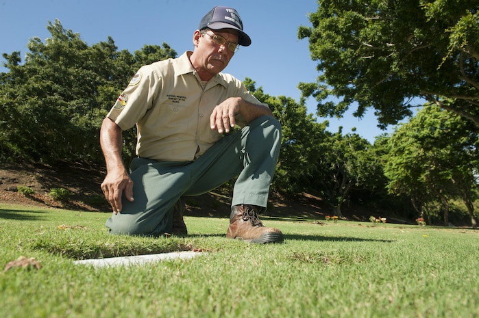 Chris Farley, U.S. Navy veteran and National Memorial Cemetery of the Pacific (NMCP) caretaker, visits the resting place of his parents at the NMCP Nov. 28, 2015, in Honolulu. Farley is a U.S. Navy veteran who served from 1982 to 1987 as an air traffic controller. He is responsible for the maintenance of the 112.5 acres of land that make up the cemetery, the 56,971 grave sites of those who are interred in-ground or in-columbarium, and the 28,788 fallen who are memorialized in the courts of the missing. (U.S. Air Force photo by Staff Sgt. Christopher Hubenthal)