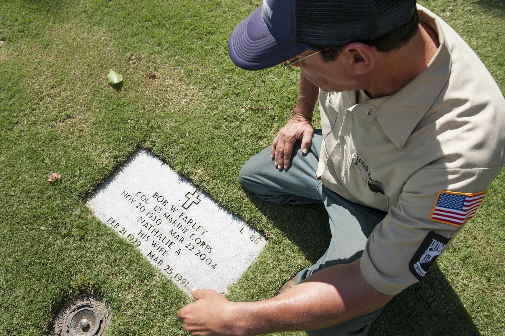 Chris Farley, U.S. Navy veteran and National Memorial Cemetery of the Pacific (NMCP) caretaker, visits the resting place of his parents at the NMCP Nov. 28, 2015, in Honolulu. Farley is a U.S. Navy veteran who served from 1982 to 1987 as an air traffic controller. He is responsible for the maintenance of the 112.5 acres of land that make up the cemetery, the 56,971 gravesites of those who are interred in-ground or in-columbarium, and the 28,788 fallen who are memorialized in the courts of the missing. (U.S. Air Force photo by Staff Sgt. Christopher Hubenthal)