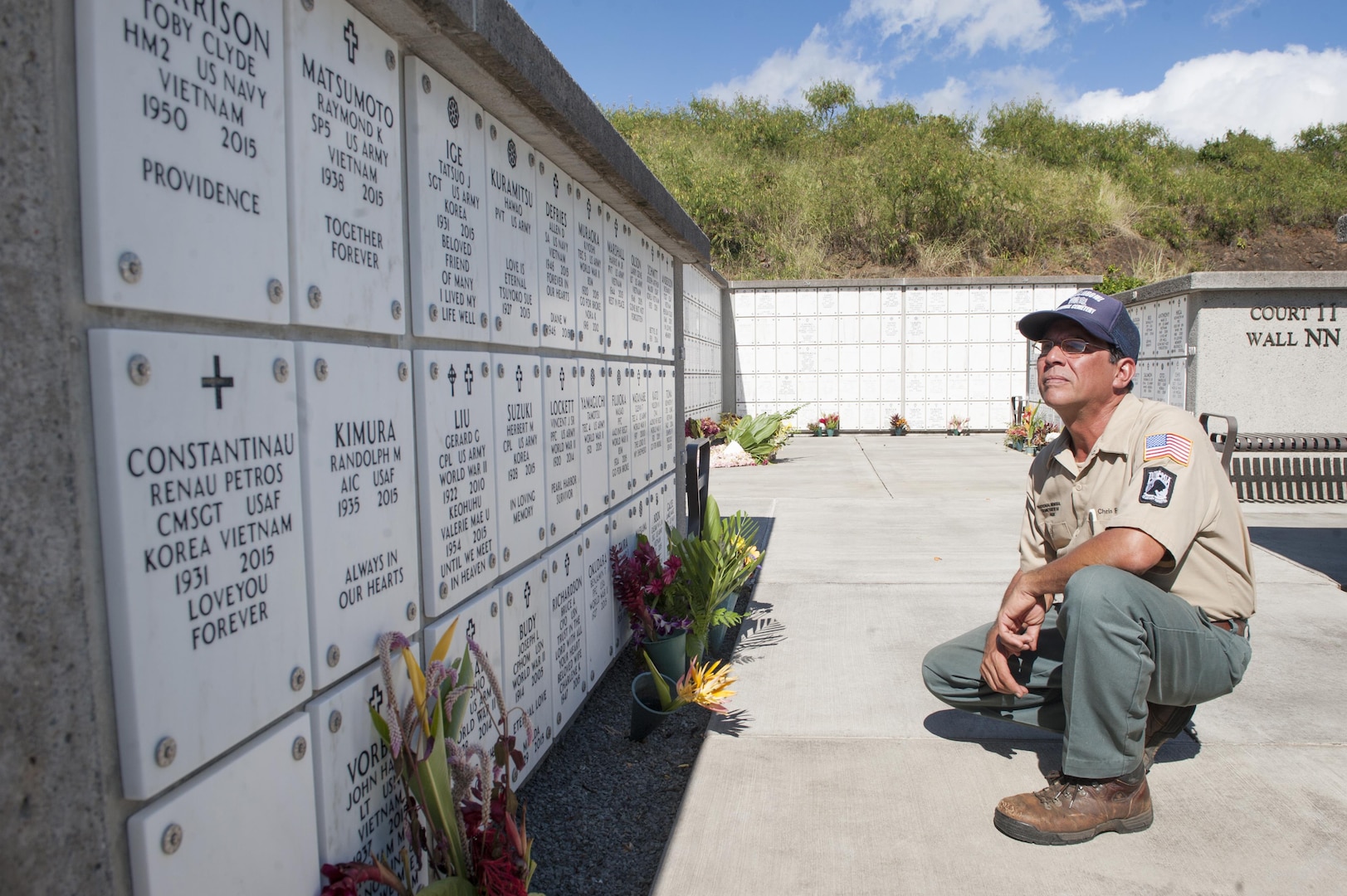 Chris Farley, U.S. Navy veteran and National Memorial Cemetery of the Pacific (NMCP) caretaker, reads names of fallen service members at the NMCP Nov. 28, 2015, in Honolulu. Farley is a U.S. Navy veteran who served from 1982 to 1987 as an air traffic controller. He is responsible for the maintenance of the 112.5 acres of land that make up the cemetery, the 56,971 gravesites of those who are interred in-ground or in-columbarium, and the 28,788 fallen who are memorialized in the courts of the missing. (U.S. Air Force photo by Staff Sgt. Christopher Hubenthal)