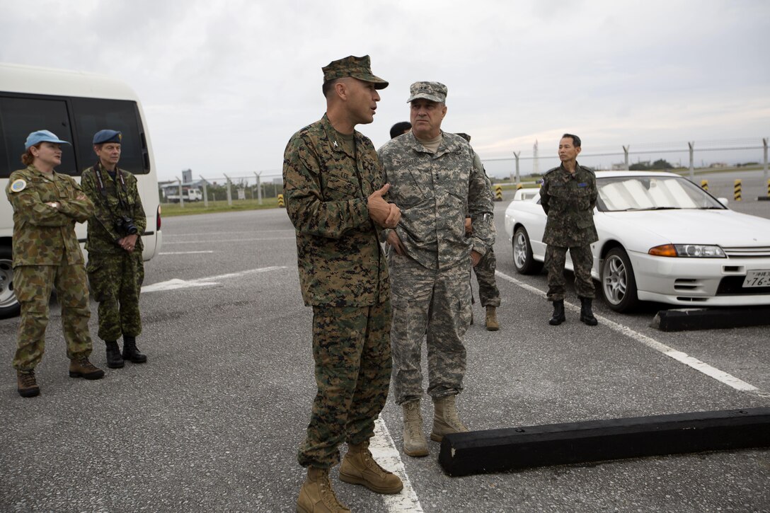 U.S. Army Maj. Gen. Kenneth Robert, right, and U.S. Marine Corps Col. Peter Lee discuss flight line capabilities Nov. 5 on Marine Corps Air Station Futenma, Okinawa, Japan. Roberts, the wartime deputy combined rear area commander for United Nations Command, and other UN command representatives attended a briefing on MCAS Futenma operations and a tour of the base. Lee, a New Rochelle, N.Y., native, is the commanding officer of MCAS Futenma.