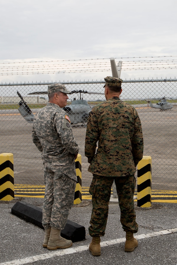 U.S. Army Maj. Gen. Kenneth Roberts, left, and U.S. Marine Corps Col. Peter Lee observe the flight line on Marine Corps Air Station Futenma, Okinawa, Japan Nov. 5. Roberts, the wartime deputy combined rear area commander for United Nations Command, and other UN command representatives attended a briefing on MCAS Futnema operations and a tour of the base. Lee, a New Rochelle, N.Y., native, is the commanding officer of MCAS Futenma.