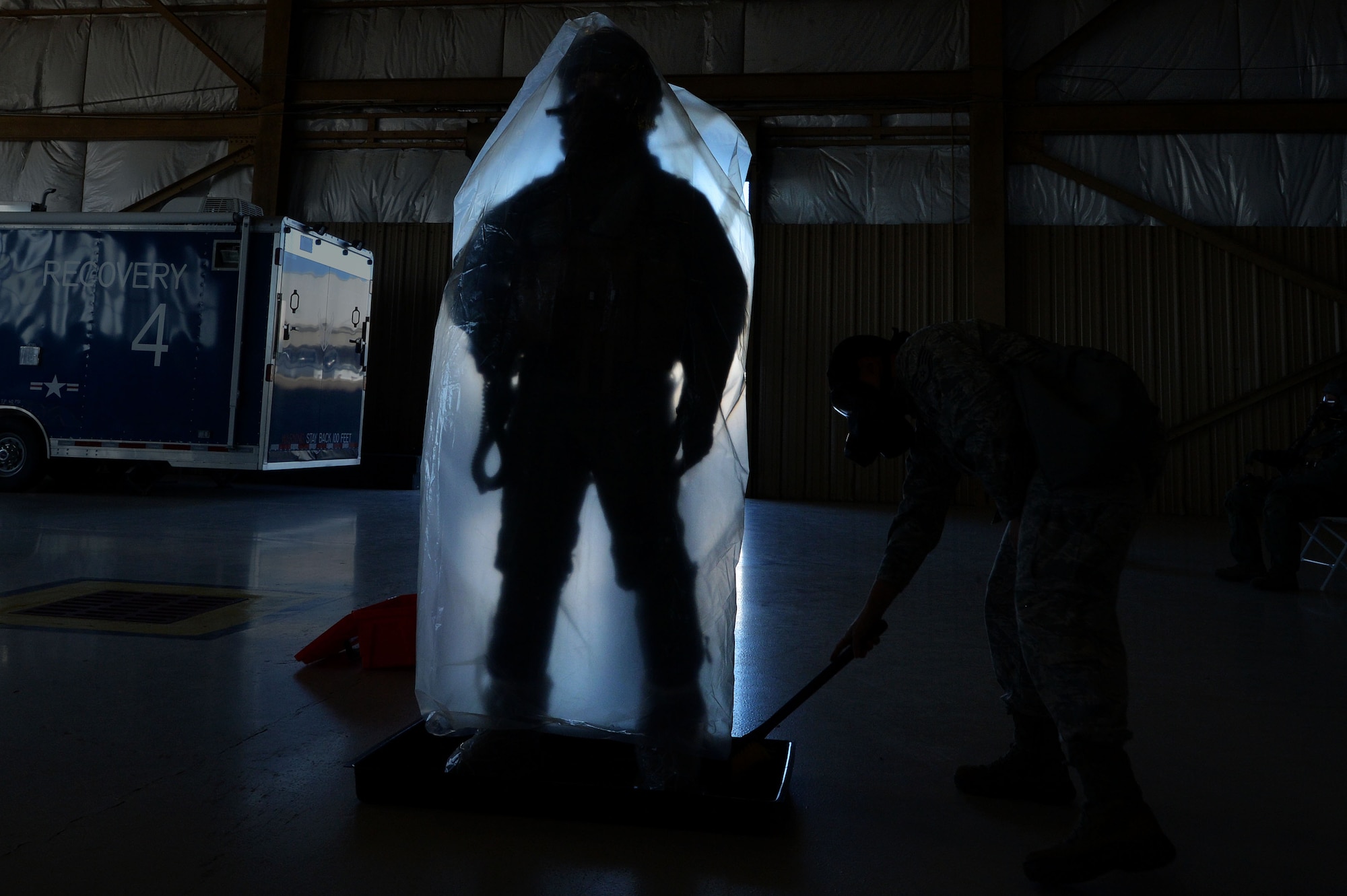 A U.S. Air Force pilot is scrubbed down during decontamination training at Shaw Air Force Base, S.C., Oct. 23, 2015. Aircrew flight equipment Airmen are in charge of making sure a pilot is properly decontaminated in the event of in-flight contamination. (U.S. Air Force photo by Senior Airman Michael Cossaboom)
