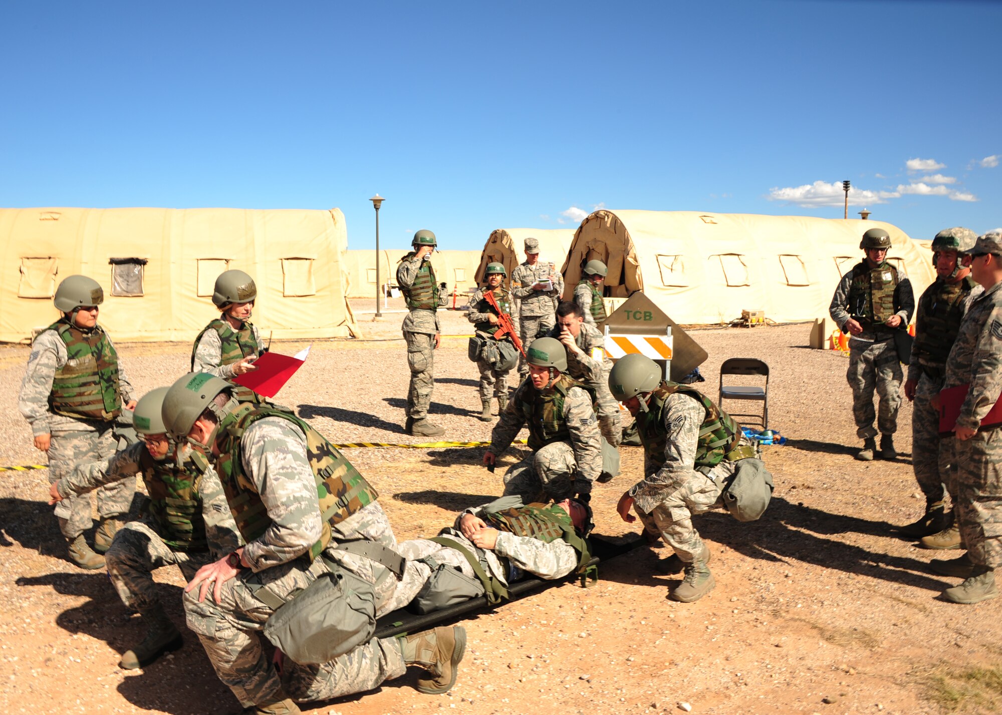 U.S. Airmen respond to a simulated heart attack patient while members of the Wing Inspection Team observe their performance during Exercise BUSHWHACKER 15-07 at Davis-Monthan Air Force Base, Ariz., Nov. 3, 2015. The Wing Inspection Team observed and graded how the 355th Fighter Wing handled and reacted to wartime scenarios. (U.S. Air Force photo by Airman Basic Nathan H. Barbour/Released)