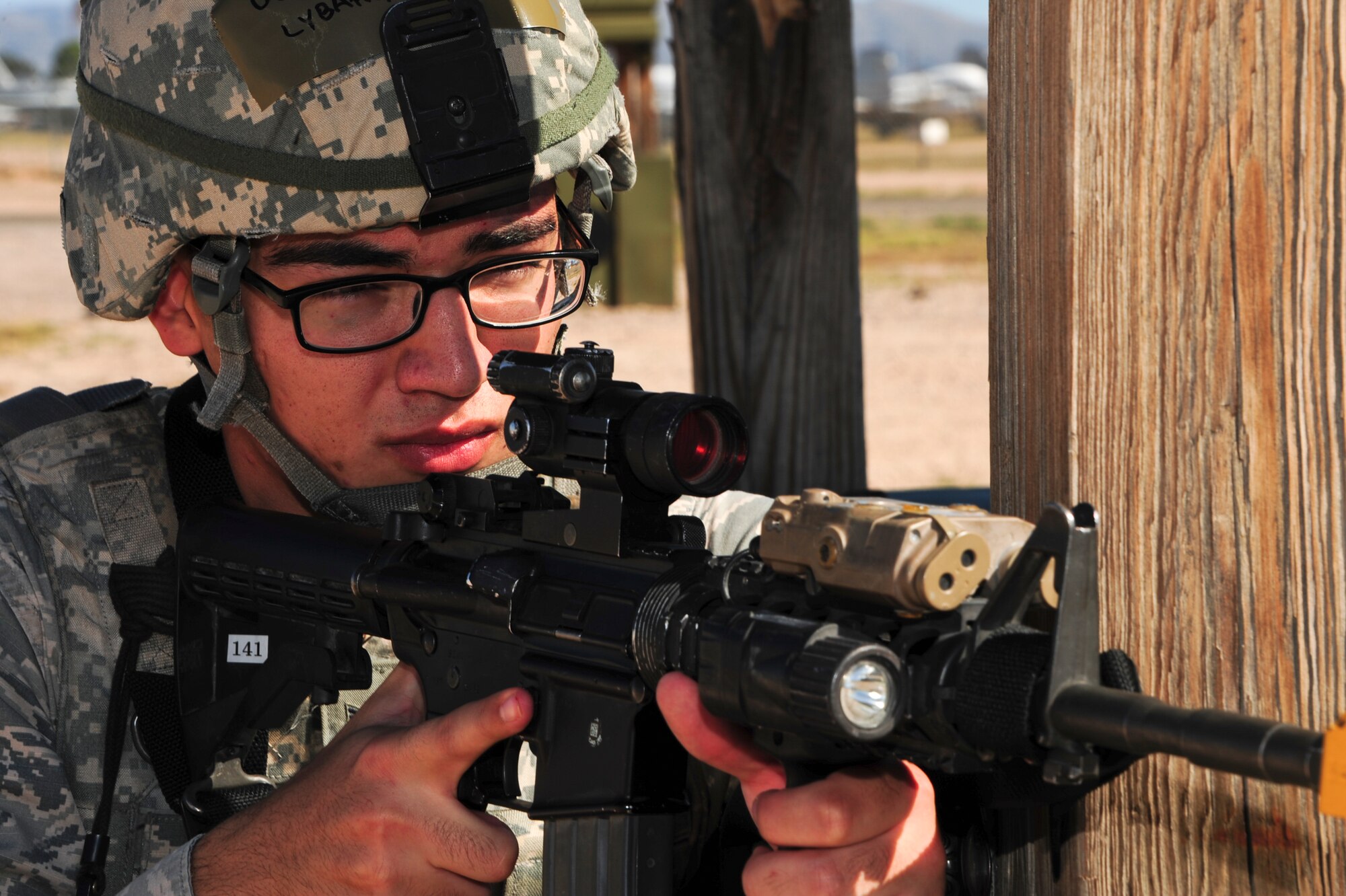 U.S. Air Force Airman 1st Class Joseph Lybarger, 355th Security Forces Squadron defender, holds an M-4 training weapon after a simulated attack during Exercise BUSHWHACKER 15-07 at Davis-Monthan Air Force Base, Ariz., Nov. 3, 2015. The operational readiness exercise tested Airmen’s abilities to defend a compound in a simulated deployed environment. (U.S. Air Force photo by Airman Basic Nathan H. Barbour/Released)
