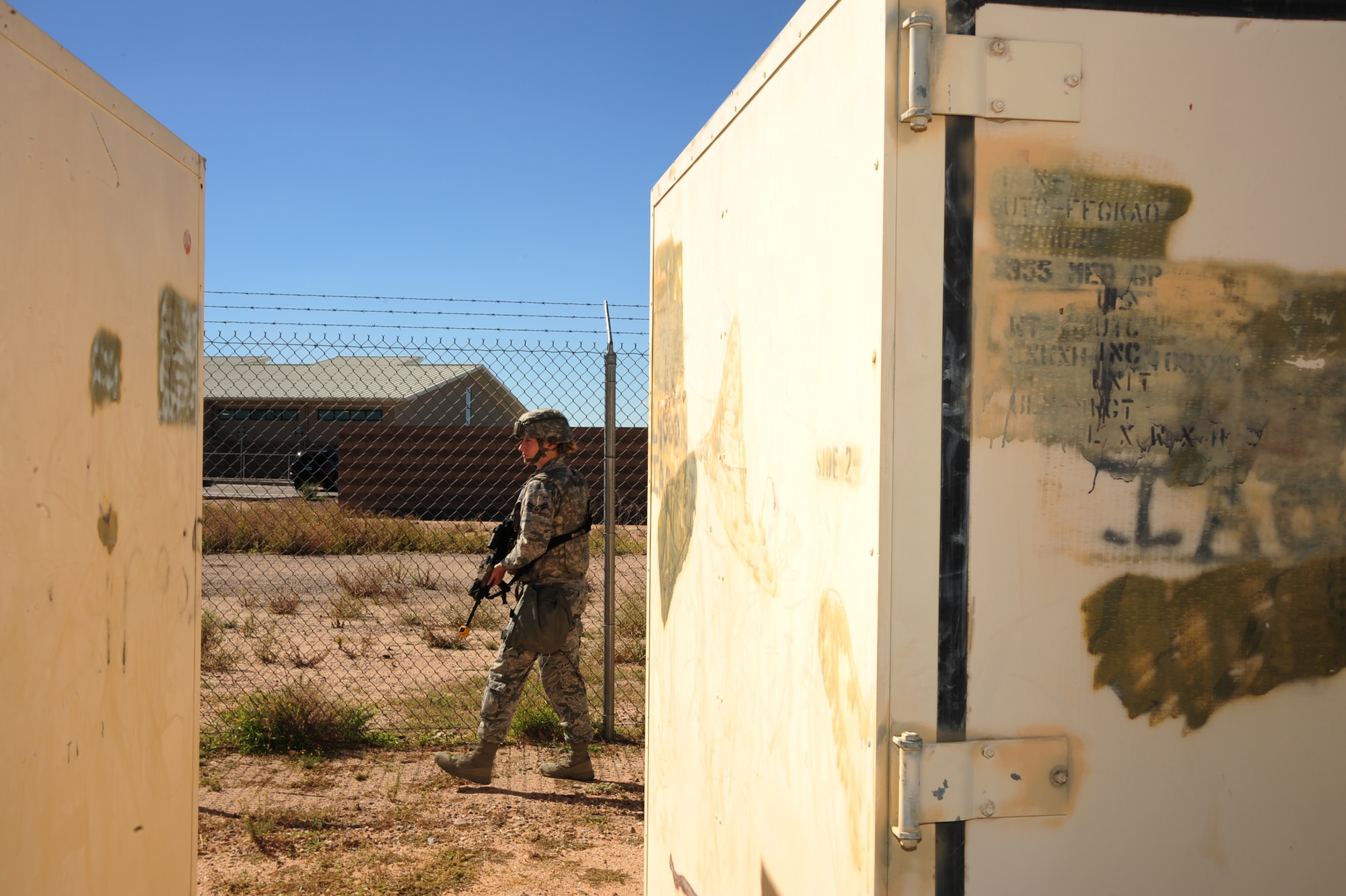 U.S. Air Force Airman 1st Class Caitlin Obee, 355th Security Forces Squadron defender, walks the perimeter of the compound during Exercise BUSHWHACKER 15-07 at Davis-Monthan Air Force Base, Ariz., Nov. 3, 2015. The operational readiness exercise tested Airmen’s abilities to defend a compound in a simulated deployed environment. (U.S. Air Force photo by Airman Basic Nathan H. Barbour/Released)