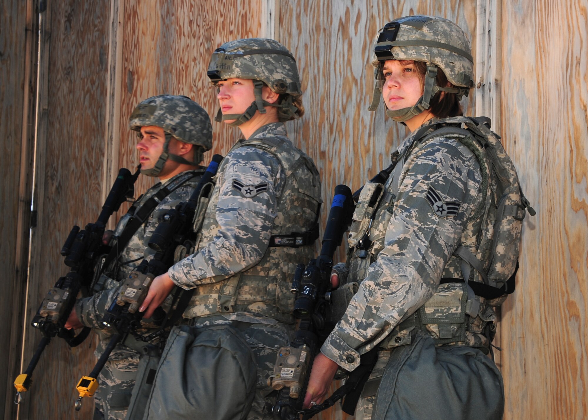 U.S. Air Force Staff Sgt. Nicolas Capriato, Airman 1st Class Caitlin Obee and Senior Airman Maria Silveira, 355th Security Forces Squadron defenders, stay alert after a simulated attack during Exercise BUSHWHACKER 15-07 at Davis-Monthan Air Force Base, Ariz., Nov. 3, 2015. The operational readiness exercise tested Airmen’s abilities to defend a compound in a simulated deployed environment. (U.S. Air Force photo by Airman Basic Nathan H. Barbour/Released