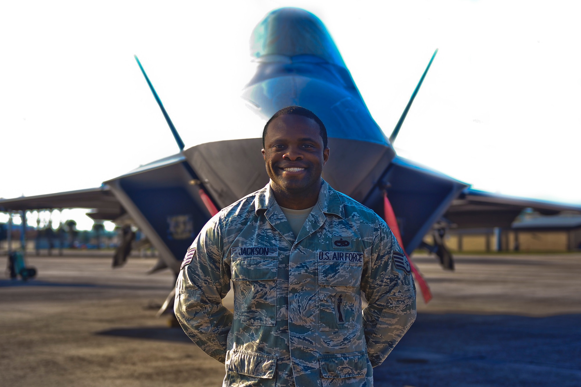 Staff Sgt. Cheyenne Jackson, 325th Aircraft Maintenance Squadron weapons load crew chief, stands in front of an F-22 Raptor Nov. 11 on the Tyndall flightline. Jackson was selected to be the 325th AMXS unsung hero for his significant contributions to the squadron. (U.S. Air Force photo by Senior Airman Dustin Mullen/Released) 