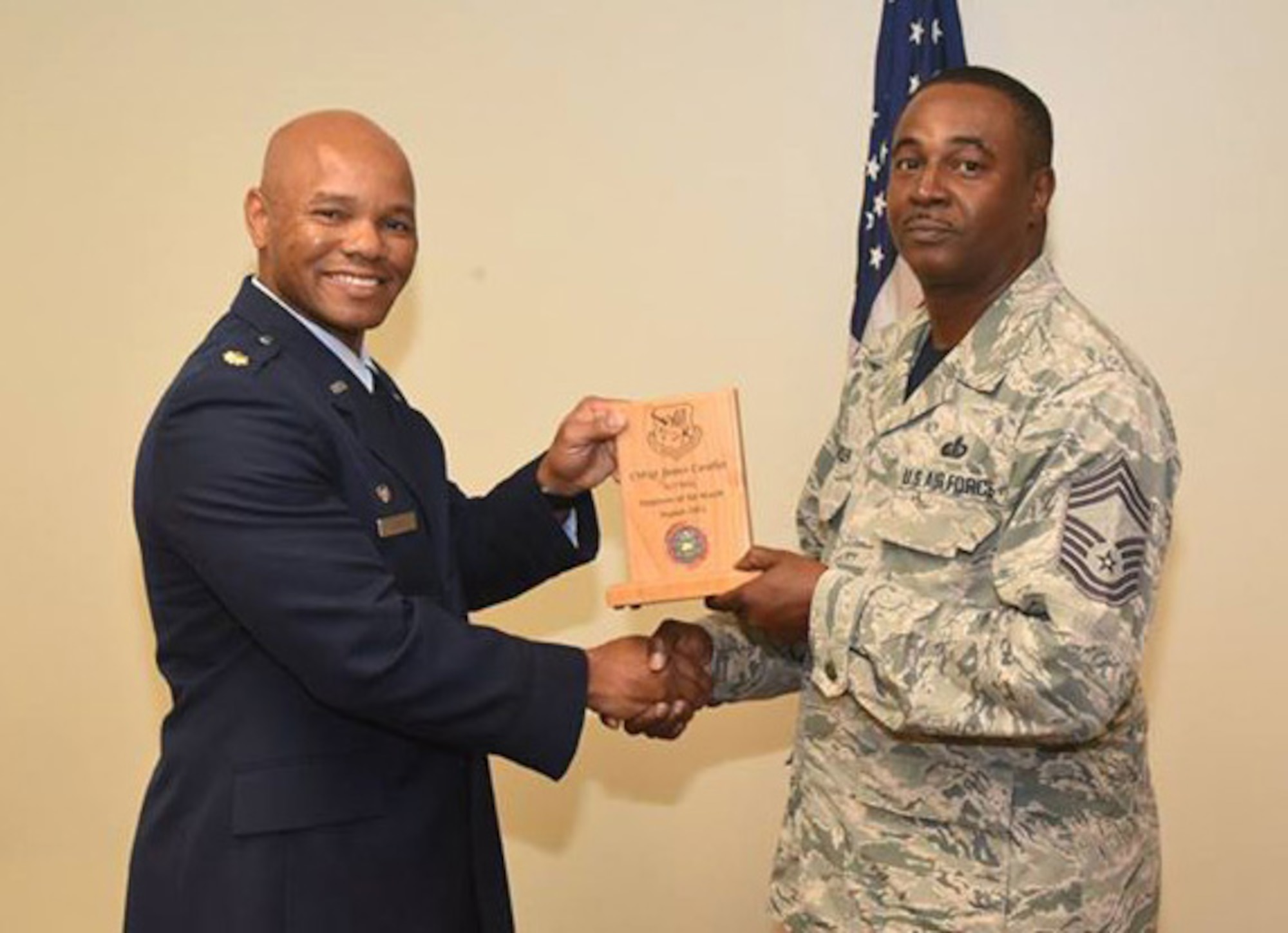 Chief Master Sgt. James Candler, 927th Force Support Squadron, Sustainment Services Superintendent, was awarded employee of the month from Maj. Rico Cicero, Saturday November 7, 2015 during the Unit Training Assembly stand up ceremony. Candler credits the Airmen of the 927 FSS for this award and accepted it on behalf of them. Cicero recalled a meeting where Candler explained why he works such long hours and always answers his phone while “off duty”, he said he will always take the call because it is our duty as leaders to take care of our Airmen. (U.S. Air Force photo by Staff Sgt. Adam C. Borgman)