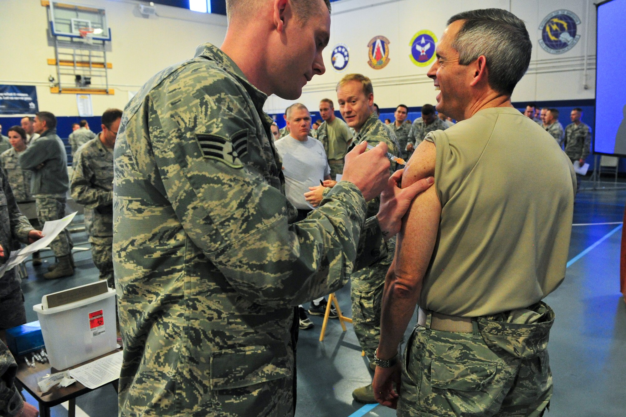 Air Force Reserve Col. Damon S. Feltman, 310th Space Wing commander, receives a seasonal flu shot from Senior Airman Brandt Hanson of the 310th Aerospace Medicine Flight during a vaccination line Nov. 7, 2015, at Schriever Air Force Base, Colo. The shot line immediately followed Feltman's commander's call.
(U.S. Air Force photo/Tech. Sgt. Nicholas B. Ontiveros)