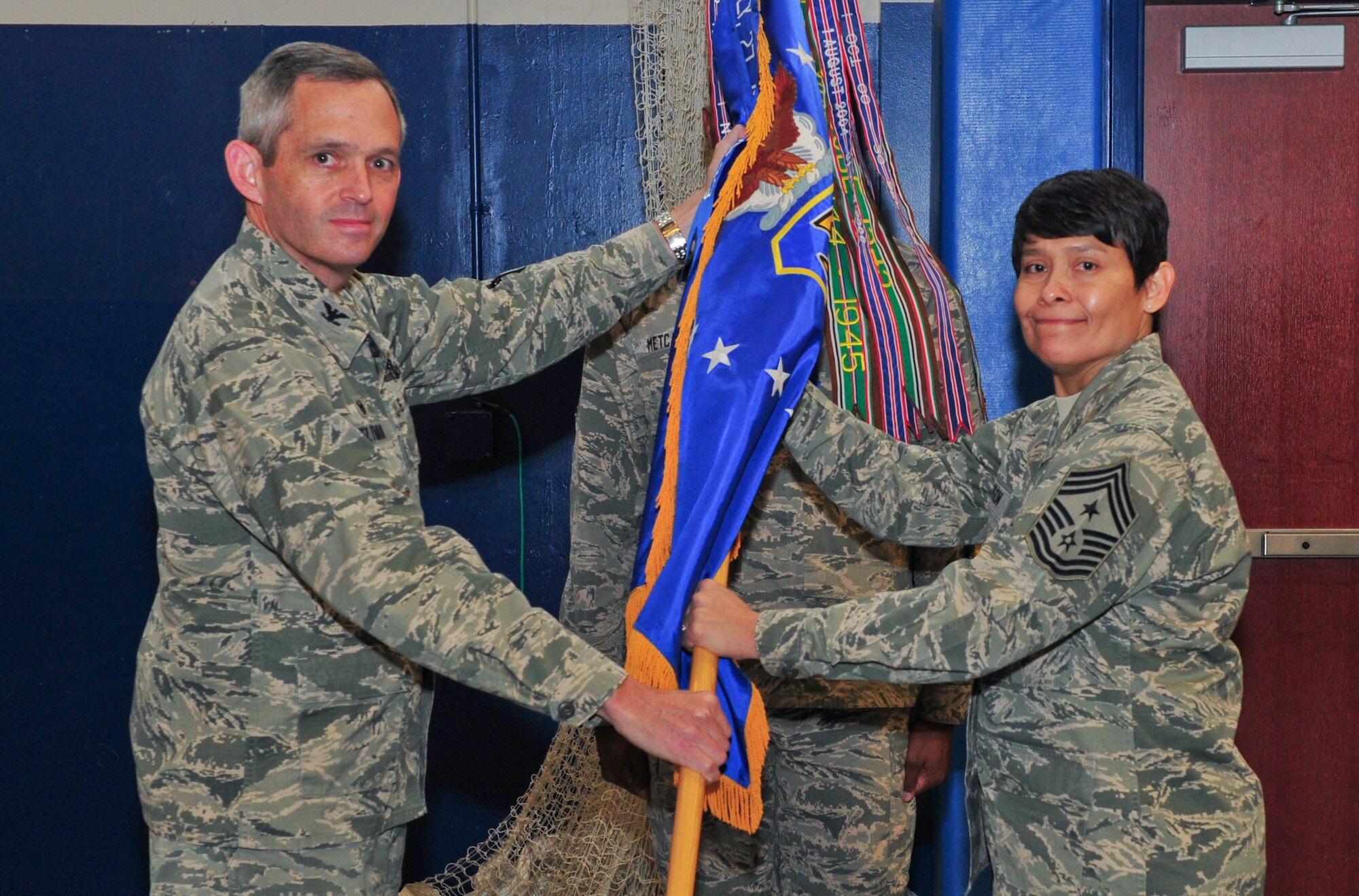 Air Force Reserve Col. Damon S. Feltman, 310th Space Wing commander presents the 310th SW guidon commemorating assumption of responsibility to Chief Master Sgt. Imelda B. Johnson as she assumes her duties as the Command Chief.
(U.S. Air Force photo/Tech. Sgt. Nicholas B. Ontiveros)