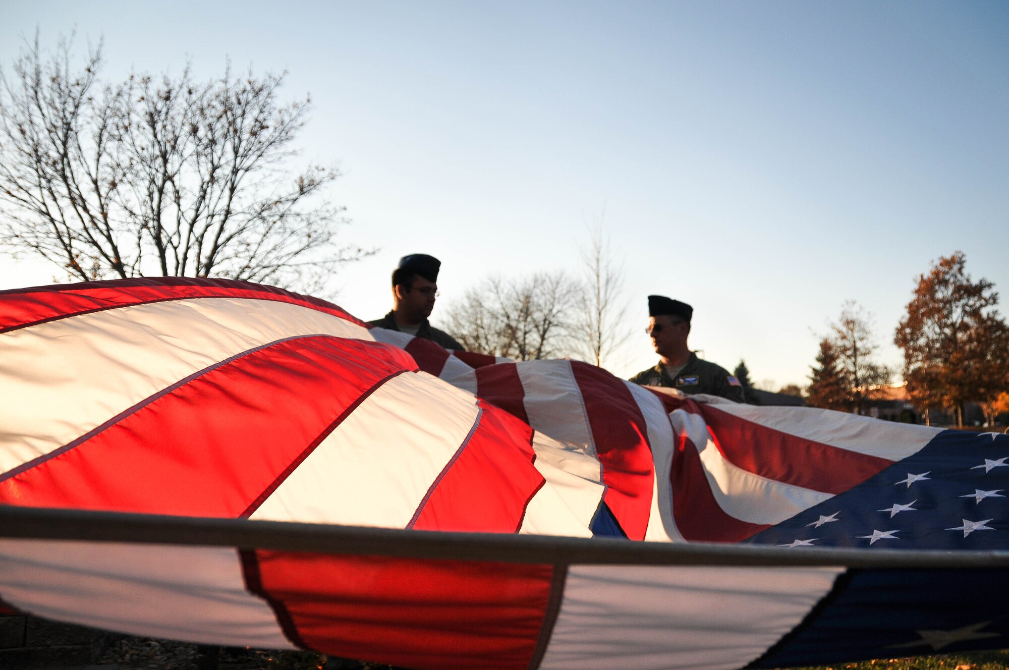 Staff Sgt. Ben Hartley, left, and Master Sgt. Zac Johnson, aeromedical evaluation technicians with the 934th Aeromedical Evacuation Squadron, fold the American flag during a retreat ceremony Nov. 7 at the Minneapolis-St. Paul International Airport Air Reserve Station, Minn. (U.S. Air Force photo by Tech. Sgt. Cherish Chavez)